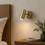 Adjustable Gold Cylinder Wall Light, Warm White — in an interior setting