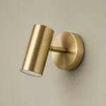 Adjustable Gold Cylinder Wall Light, Warm White — complete fixture in an interior setting