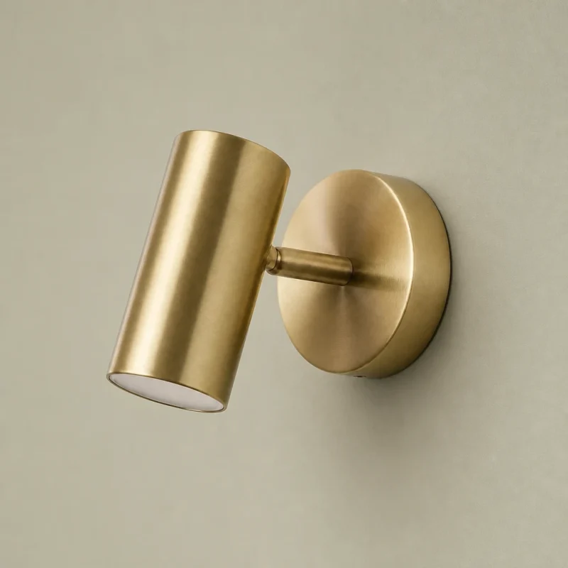 Adjustable Gold Cylinder Wall Light, Warm White — complete fixture in an interior setting
