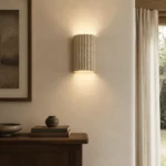 Fluted Travertine Up and Down Wall Light — in an interior setting
