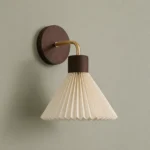 Pleated Fabric and Wood Wall Sconce, Brown — complete fixture in an interior setting