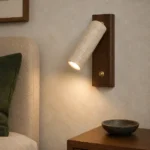 Travertine Reading Wall Light with Walnut Backplate — in an interior setting